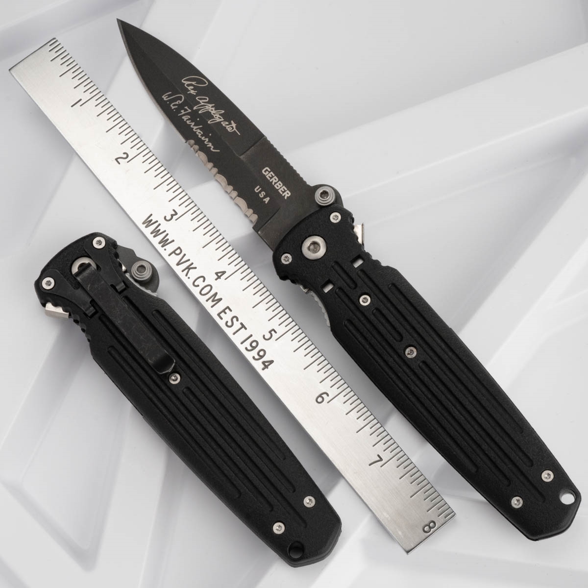 Double edged combat folder with serrated side and ambiextrous grip